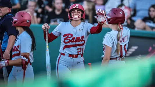 Ana Roman (21) high fives Larissa Preuitt (11) vs. West Alabama (Oct. 10, 2025)