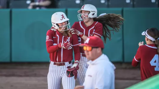 Audrey Vandagriff (12) and Gerritt Griggs (2) celebrate after a home run vs. Itawamba (Oct. 19, 2025)