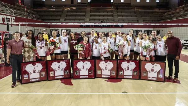 Alabama volleyball players and coaches posing on the court celebrating senior day vs. Missouri (Nov. 16, 2025)