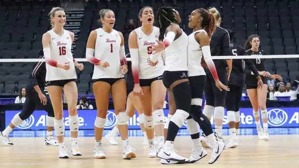 Victoria Barrett (12) and Ryelle Rondo (17) chest bump while teammates cheer vs. South Carolina at the SEC Tournament (Nov. 21, 2025)