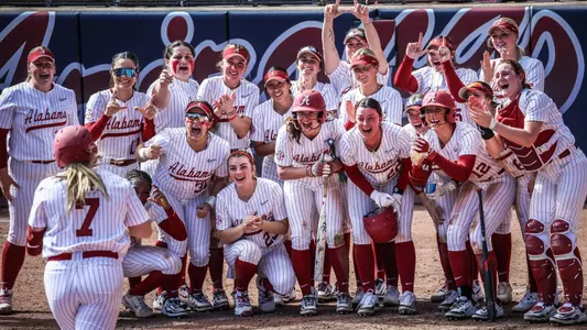 Catelyn Riley (7) heads home as her teammates await at home plate following a home run vs. Michigan State (Feb. 7, 2025)