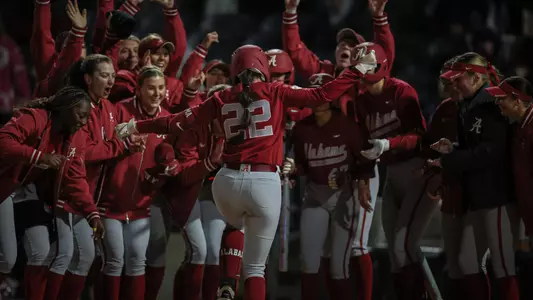 Kali Heivilin (22) heads home as her teammates await following a home run vs. Jacksonville State (Feb. 18, 2025)