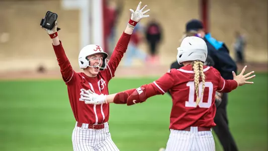 Larissa Preuitt (11) hugs Abby Duchscherer (10) after a game-winning hit vs. Virginia Tech (Feb. 23, 2025)