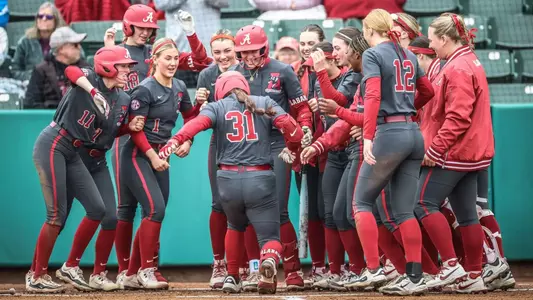 Alexis Pupillo (31) steps on home plate as her teammates await following a home run vs. Drake (Feb. 22, 2025)