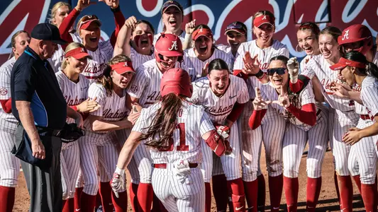 Alexis Pupillo (31) celebrates at home plate with her teammates after hitting a home run vs. Washington (Feb. 7, 2025)