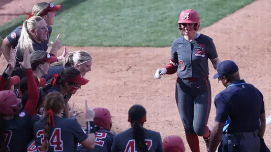 Brooke Ellestad (00) celebrates with teammates following a home run vs. Furman (March 1, 2025)