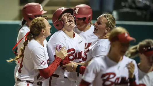 Catelyn Riley (7) laughs with Marlie Giles (34) and Emily Winstead (13) after a home run vs. Iowa (March 7, 2025)