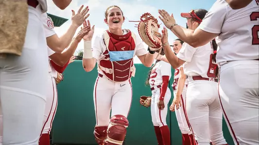 Marlie Giles (34) high fives teammates as she runs out for starting lineups vs. Mississippi State (March 14, 2025)