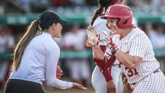 Alexis Pupillo (31) high fives Kayla Braud after a base hit vs. Florida State (March 19, 2025)