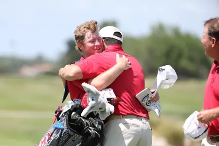 Jones Free celebrates making a putt to help Alabama reach match play at the SEC Championships