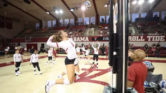 Laney Hennessee hitting on right side during warmups before playing UNC Asheville.