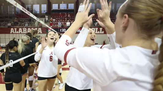 Maggie Kyriakides clapping teammate after shaking hands with opposing team, UNC Asheville, following the match.