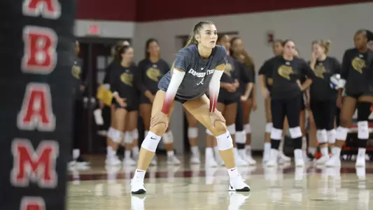 Laney Hennessee on court during warm ups waiting in serve receive position.