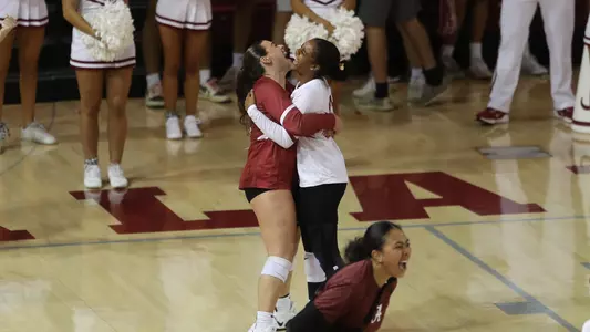 Ryelle Rondo hugging teammate, Trinity Stanger, while celebrating point win against Wake Forest.