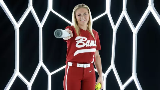 Holly Beth Brooks posing for media day in front of hexagon lighting.