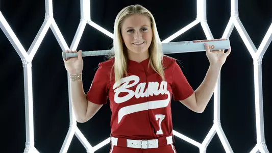 Holly Beth Brooks posing for media day in front of hexagon lighting structure.
