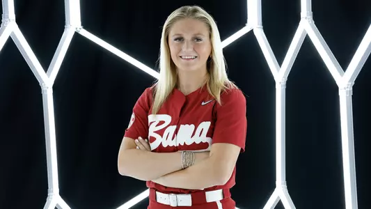 Holly Beth Brooks posing for media day in front of hexagon lighting structure.