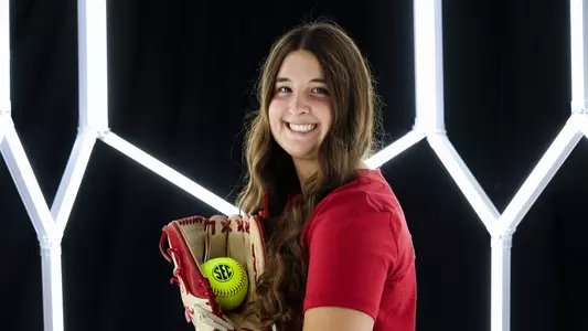 Kaitlyn Pallozzi posing for media day in front of hexagon lighting structure.