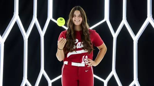 Kaitlyn Pallozzi posing for media day in front of hexagon lighting structure.