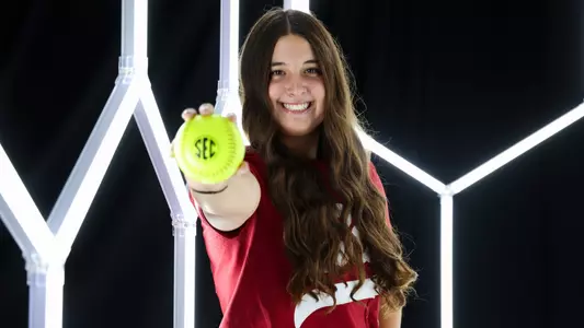 Kaitlyn Pallozzi posing for media day in front of hexagon lighting structure.