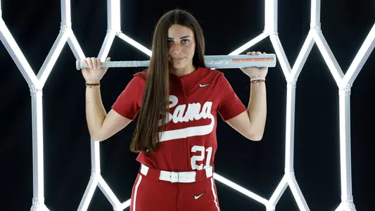 Ana Roman posing for media day in front of hexagon lighting structure.