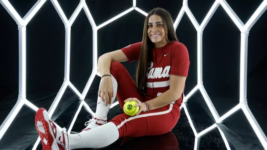 Ana Roman posing for media day in front of hexagon lighting structure.