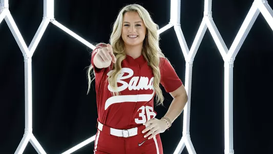 Ambrey Taylor posing for media day in front of hexagon lighting structure.