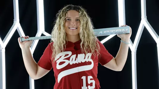 Brooke Wells posing for media day in front of hexagon lighting structure.