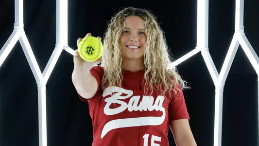 Brooke Wells posing for media day in front of hexagon lighting structure.