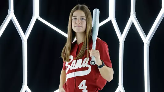 Jena Young posing for media day in front of hexagon lighting structure.