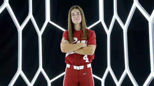 Jena Young posing for media day in front of hexagon lighting structure.