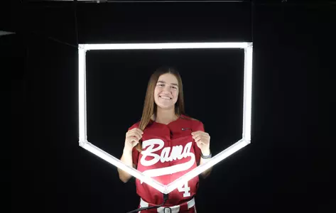 Jena Young posing for media day in front of hexagon lighting structure.