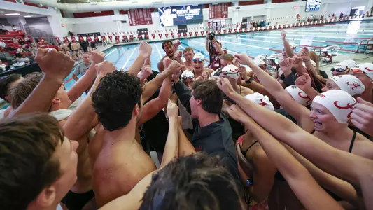 Swimming and diving cheer after the meet
