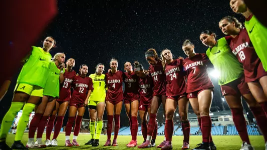 Alabama soccer team standing in rain