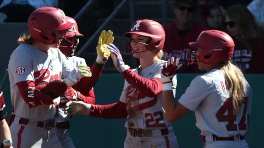 Alabama players celebrate after an Audrey Vandagriff (12) home run