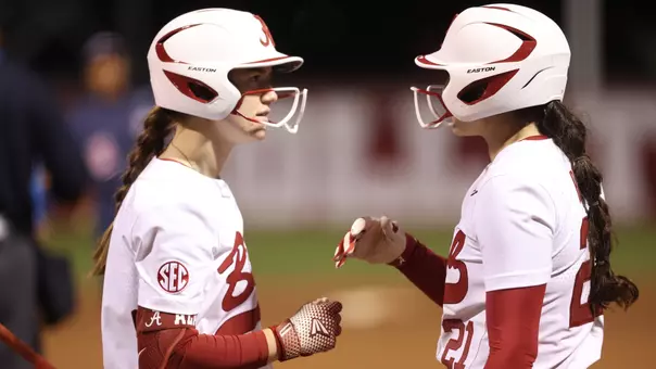 Jena Young (4) and Ana Roman (21) talk between at-bats vs. Liberty (Feb. 13, 2026)
