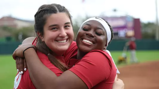 Kaitlyn Pallozzi (31) and Vic Moten (00) hugging and smiling pregame vs. Elon (Feb. 20, 2026)