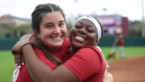 Kaitlyn Pallozzi (31) and Vic Moten (00) hugging and smiling pregame vs. Elon (Feb. 20, 2026)