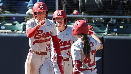 Audrey Vandagriff (12) points at Salen Hawkins (47) after scoring runs vs. East Carolina (Feb. 6, 2026)