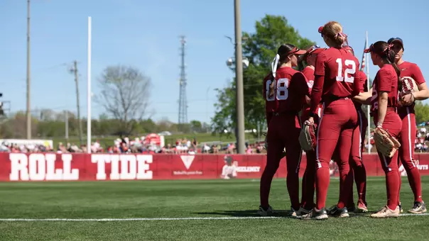 Alabama softball players together pregame on the field vs. Arkansas (March 14, 2026)
