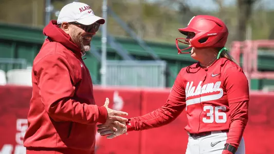 Patrick Murphy high fives Ambrey Taylor (36) at third base vs. ULM (March 17, 2026)