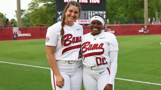 Kaitlyn Pallozzi (19) and Vic Moten (00) pose together for a picture pregame vs. Texas (April 2, 2026)