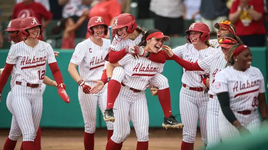 Ana Roman (#21) gives Jena Young (#4) a piggyback ride after Young hit a home run vs. Texas (April 4, 2026)