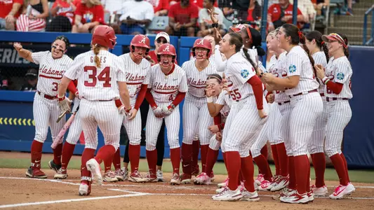 Marlie Giles (34) celebrates at home plate with teammates after a home run vs. Nebraska (May 30, 2026)