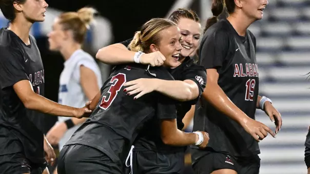 Avery Brown (3) and Larkin Thomason (7) hug after a late goal vs. Saint Louis (Aug. 12, 2026)