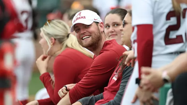 Alabama pitching coach Lance McMahon laughs with the players in the dugout vs. Florida State (Feb. 21, 2026)