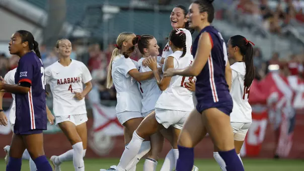 Alabama soccer players celebrate with Larkin Thomason (7) after a goal vs. TCU (Aug. 20, 2026)