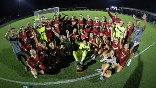 Alabama soccer posing with the Iron Bowl trophy after beating Auburn (Sept. 11, 2026)