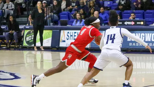 Khiana dribbling by defender