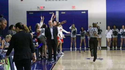 Celebration behind Coach McGuire at Longwood 1/14/20